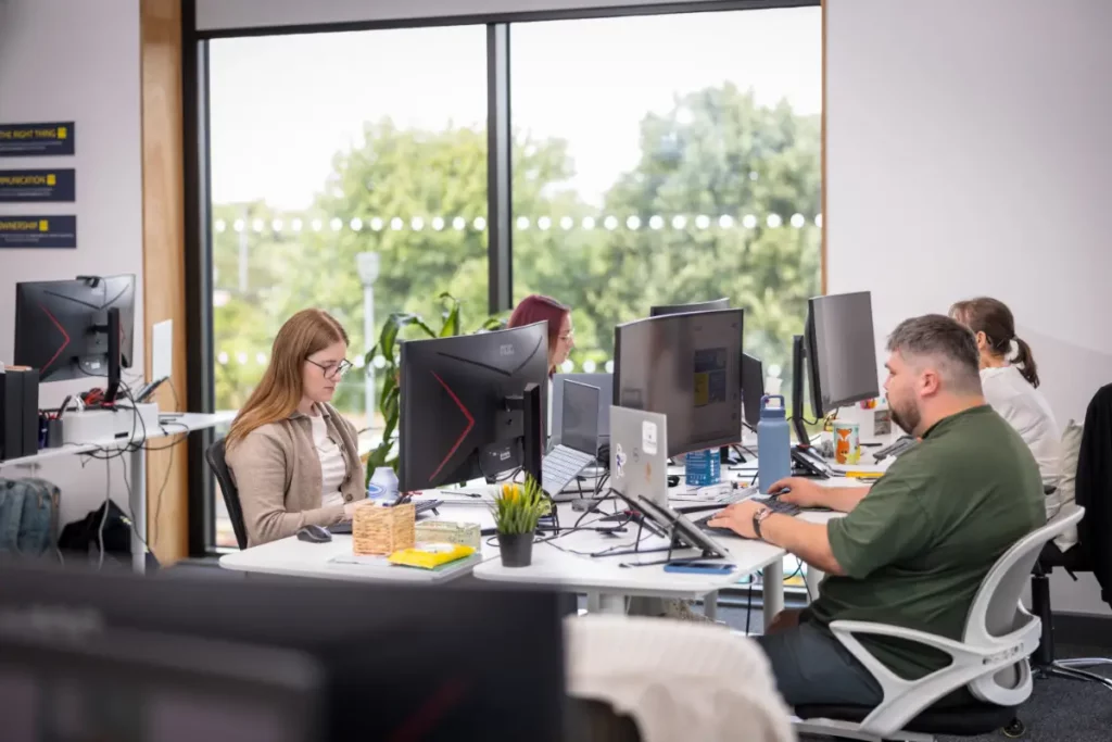 Tayler and Kieran working at their desks in Wingman UK office