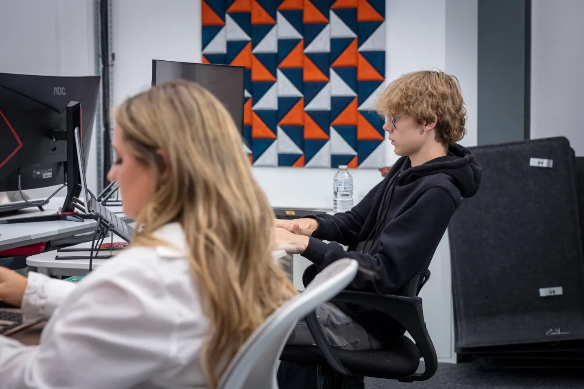 Tayler and Kieran working at their desks in Wingman UK office