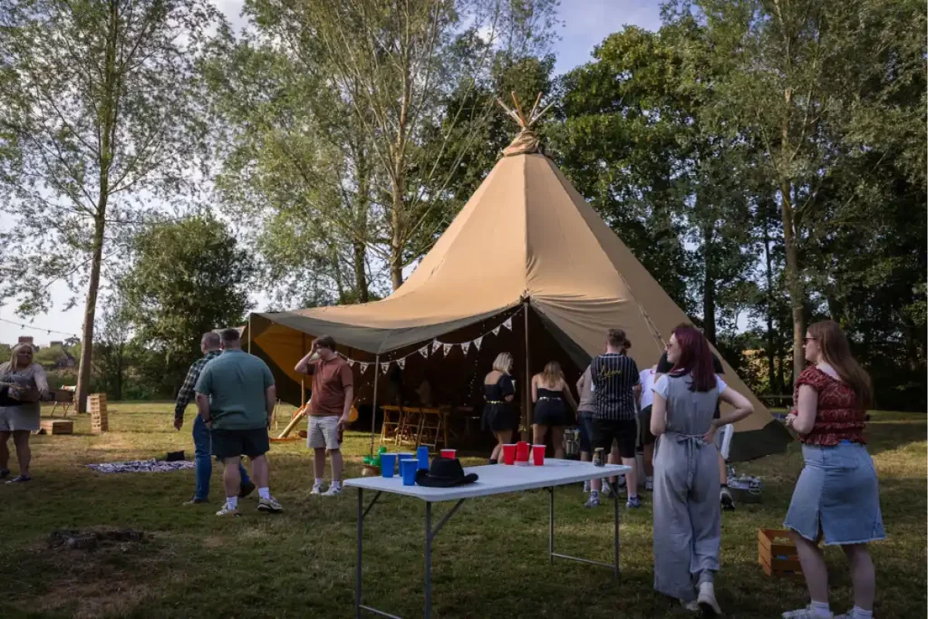 Wingman summer party 2025, staff grouped under and around teepee